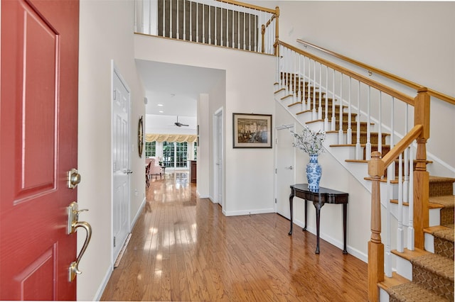12 Miro Pl Unit 31, Port Washington, NY 11050 - entryway with wood-type flooring, stairway, a ceiling fan, and a towering ceiling