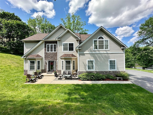 41 Moison Rd N, Blauvelt, NY 10913 - view of front of home with stone siding, a front lawn, a patio, and roof with shingles