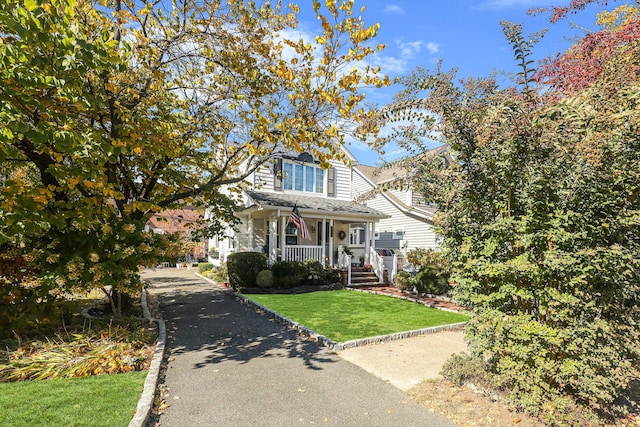 95-01 72nd Ave, Forest Hills, NY 11375 - view of front of property featuring covered porch and a front yard