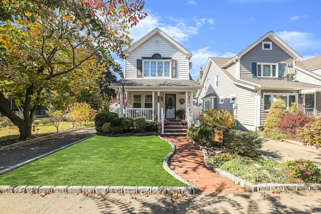 95-01 72nd Ave, Forest Hills, NY 11375 - traditional home featuring a porch and a front yard