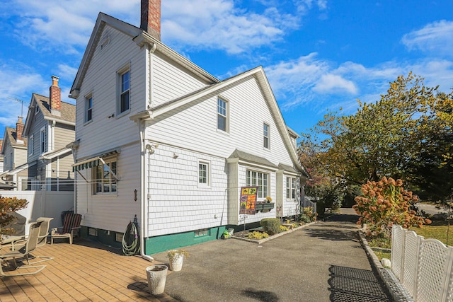 95-01 72nd Ave, Forest Hills, NY 11375 - view of home's exterior with a chimney and a deck