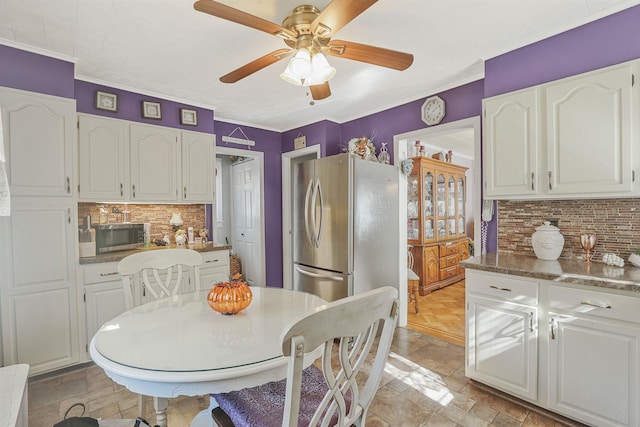 95-01 72nd Ave, Forest Hills, NY 11375 - kitchen featuring appliances with stainless steel finishes, white cabinetry, tasteful backsplash, ceiling fan, and ornamental molding