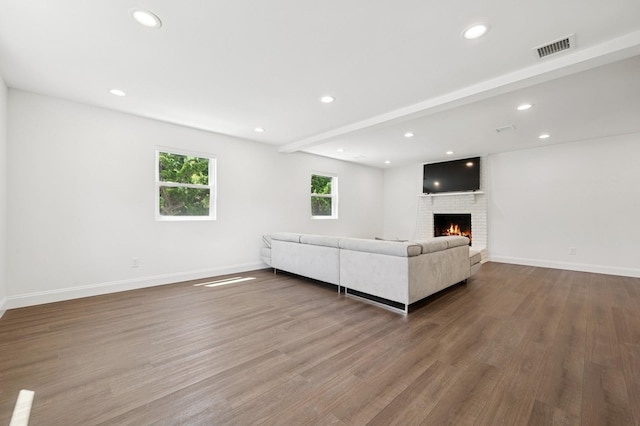 42 Chernucha Ave, Merrick, NY 11566 - unfurnished living room featuring wood finished floors, a fireplace, baseboards, and recessed lighting
