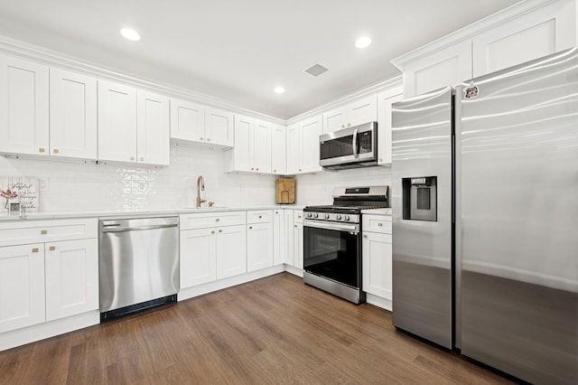 42 Chernucha Ave, Merrick, NY 11566 - kitchen featuring appliances with stainless steel finishes, a sink, light countertops, backsplash, and white cabinets