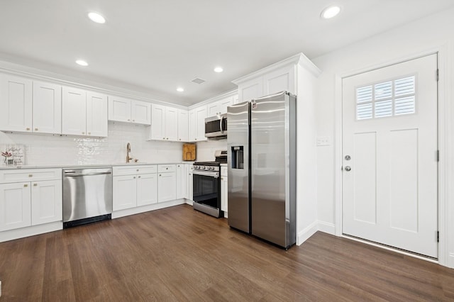 42 Chernucha Ave, Merrick, NY 11566 - kitchen featuring stainless steel appliances, dark wood finished floors, white cabinetry, backsplash, and a sink