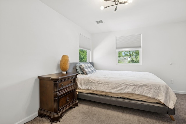 42 Chernucha Ave, Merrick, NY 11566 - carpeted bedroom with a chandelier and baseboards