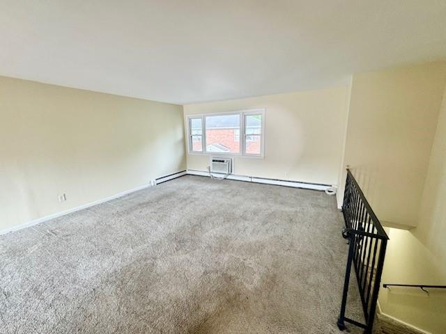 1668 Rte 9 Unit 13E, Wappingers Falls, NY 12590 - spare room featuring carpet floors, baseboards, and a wall mounted air conditioner