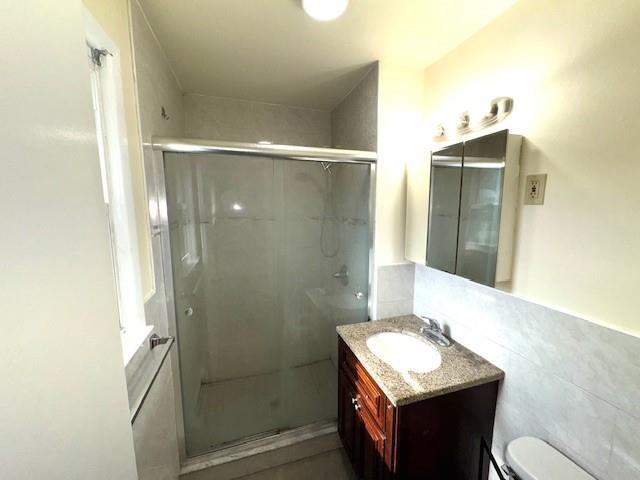 1668 Rte 9 Unit 13E, Wappingers Falls, NY 12590 - bathroom with vanity, a shower stall, and toilet