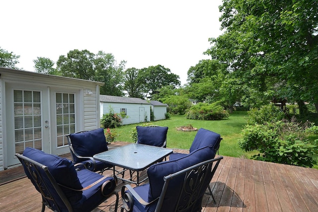 1578 N Thompson Dr, Bay Shore, NY 11706 - wooden deck featuring a yard, outdoor dining area, an outbuilding, and french doors
