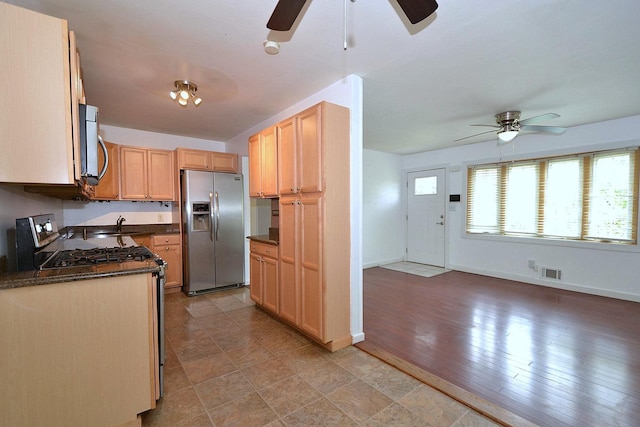 1578 N Thompson Dr, Bay Shore, NY 11706 - kitchen featuring stainless steel appliances, a ceiling fan, dark countertops, and light brown cabinetry
