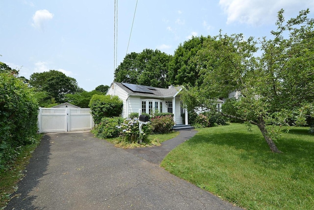 1578 N Thompson Dr, Bay Shore, NY 11706 - view of front of home featuring solar panels and a gate