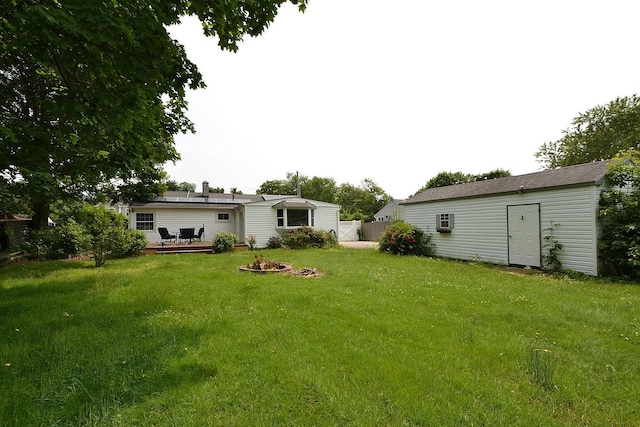 1578 N Thompson Dr, Bay Shore, NY 11706 - view of yard featuring a deck, an outdoor structure, and a fire pit