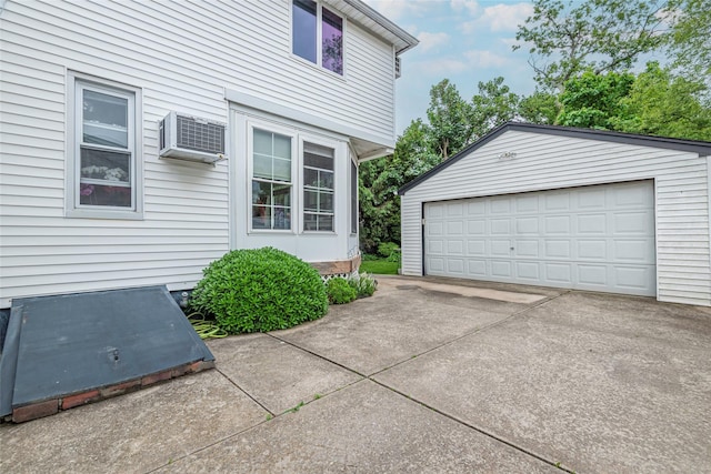 103 Fairfield Ave, Mineola, NY 11501 - view of side of home with an outdoor structure, a wall unit AC, and a detached garage