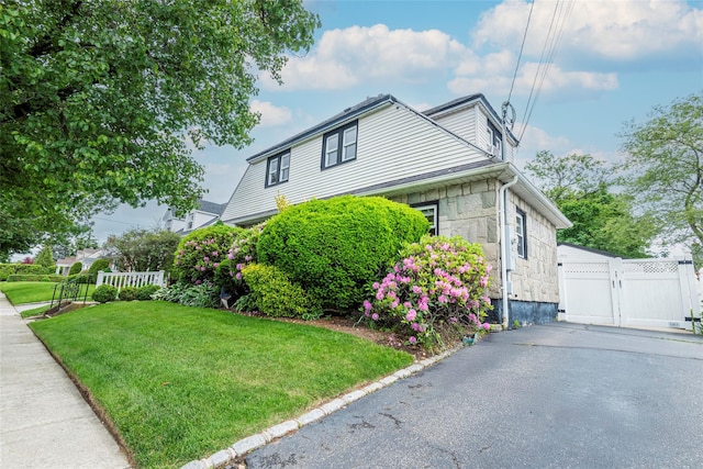 103 Fairfield Ave, Mineola, NY 11501 - view of side of property featuring a gate and stone siding
