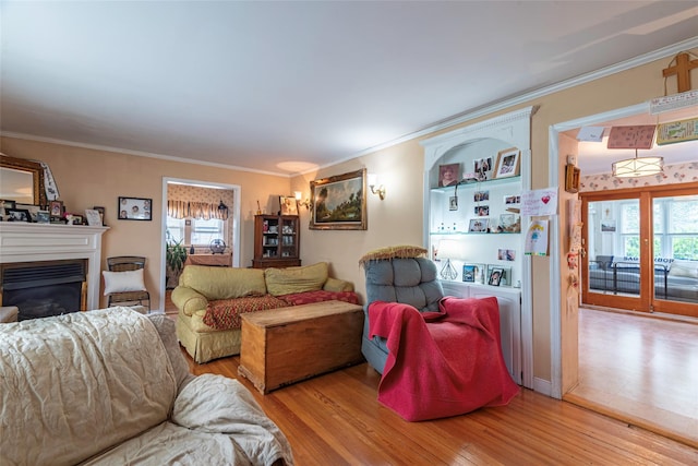 103 Fairfield Ave, Mineola, NY 11501 - living area with healthy amount of natural light, wood finished floors, crown molding, and a glass covered fireplace