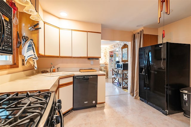103 Fairfield Ave, Mineola, NY 11501 - kitchen featuring black appliances, a sink, light countertops, white cabinets, and light flooring