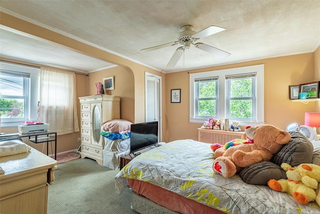 103 Fairfield Ave, Mineola, NY 11501 - bedroom featuring carpet flooring, ornamental molding, a ceiling fan, arched walkways, and a closet
