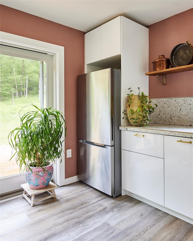 546 Willowemoc Rd, Livingston Manor, NY 12758 - kitchen featuring freestanding refrigerator, light countertops, white cabinetry, light wood-type flooring, and open shelves