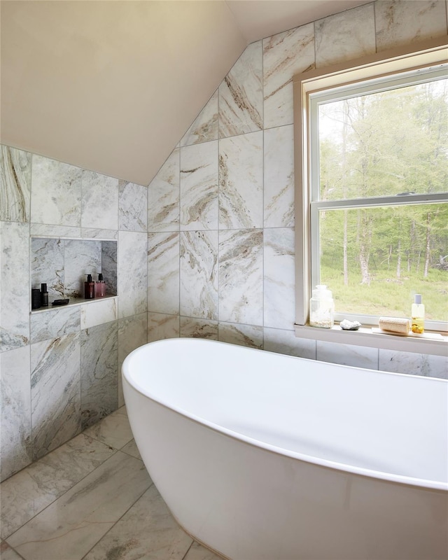 546 Willowemoc Rd, Livingston Manor, NY 12758 - full bathroom with tile walls, lofted ceiling, a soaking tub, and marble finish flooring