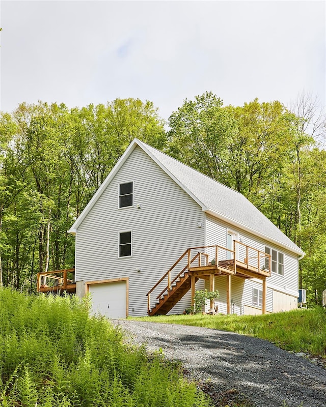 546 Willowemoc Rd, Livingston Manor, NY 12758 - view of front of property featuring a wooden deck, stairs, driveway, and roof with shingles