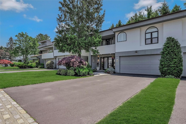51 Eagle Chase, Woodbury, NY 11797 - view of front of property with an attached garage, driveway, a front lawn, stucco siding, and a balcony