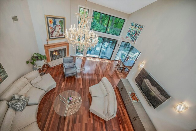 51 Eagle Chase, Woodbury, NY 11797 - living room with wood finished floors, a chandelier, a high ceiling, and a fireplace