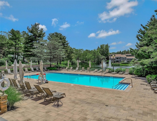 51 Eagle Chase, Woodbury, NY 11797 - community pool featuring a patio area, view of scattered trees, and a water view