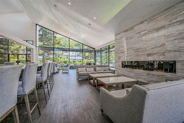 51 Eagle Chase, Woodbury, NY 11797 - living room with high vaulted ceiling, a tile fireplace, a sunroom, hardwood / wood-style flooring, and recessed lighting