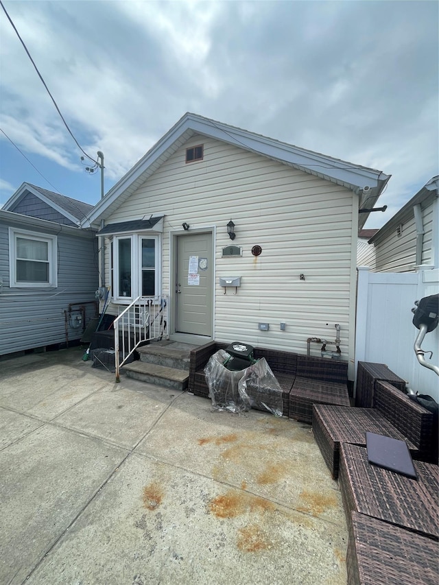 8 Church St, Howard Beach, NY 11414 - rear view of house featuring a patio