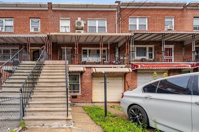 3739 Barnes Ave, Bronx, NY 10467 - view of front of property featuring brick siding, a garage, and stairway