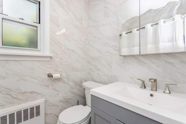 352 N State Rd Unit 2H, Briarcliff Manor, NY 10510 - bathroom featuring radiator heating unit, tile walls, vanity, toilet, and a shower with curtain