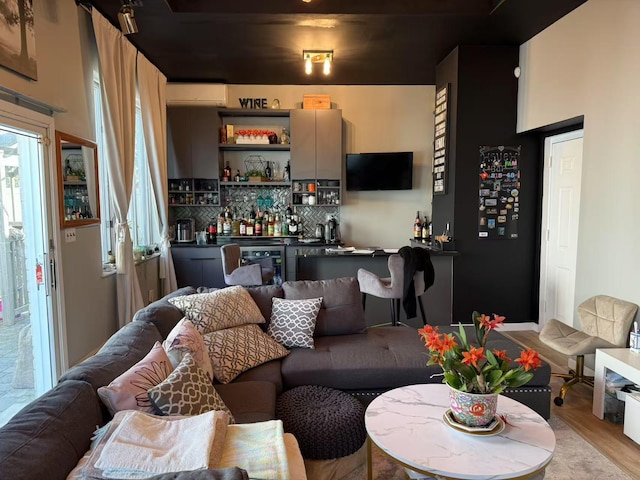 215-48 24th Ave, Bayside, NY 11360 - living area featuring bar area, a wall unit AC, and light wood-style floors