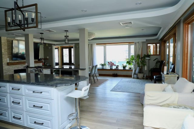 215-48 24th Ave, Bayside, NY 11360 - kitchen featuring open floor plan, white cabinets, dark stone countertops, and light wood-type flooring