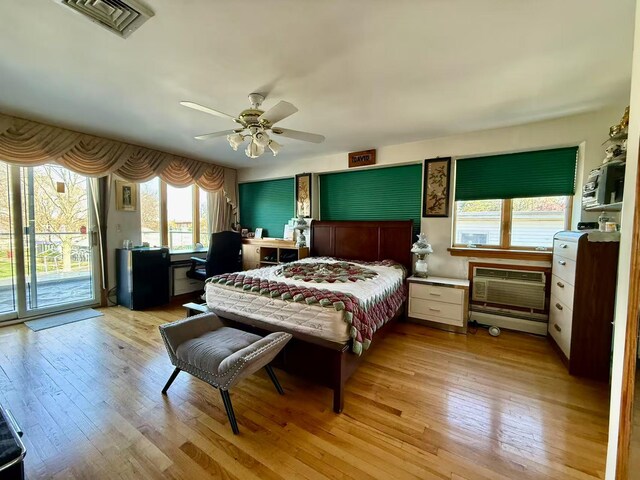 215-48 24th Ave, Bayside, NY 11360 - bedroom with access to exterior, light wood-style flooring, a wall mounted air conditioner, and ceiling fan