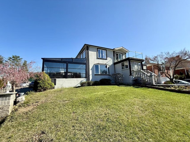 215-48 24th Ave, Bayside, NY 11360 - rear view of house featuring a lawn and stucco siding