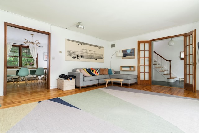 8 Margaret Dr, Hopewell Junction, NY 12533 - living room with wood finished floors, stairs, and a baseboard radiator