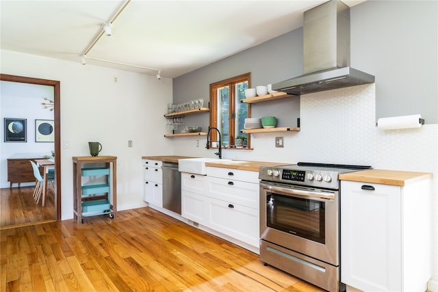 8 Margaret Dr, Hopewell Junction, NY 12533 - kitchen with stainless steel appliances, butcher block countertops, wall chimney exhaust hood, and open shelves