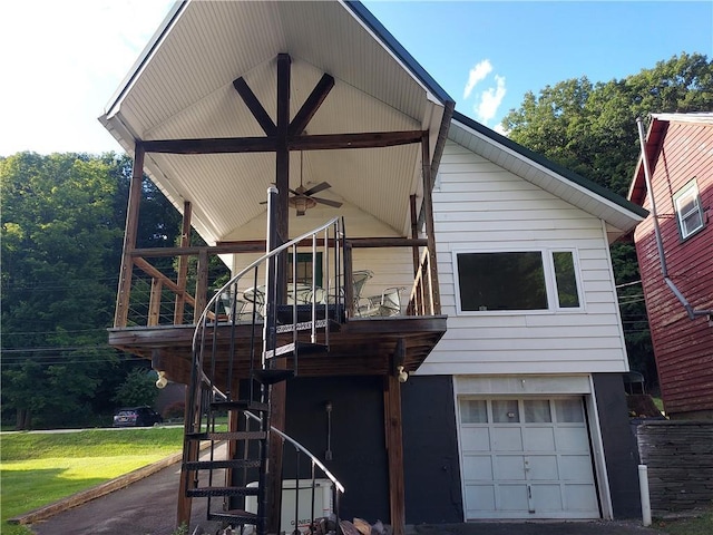 460 E Front St, Hancock, NY 13783 - rear view of property featuring stairs, a garage, a yard, and a ceiling fan