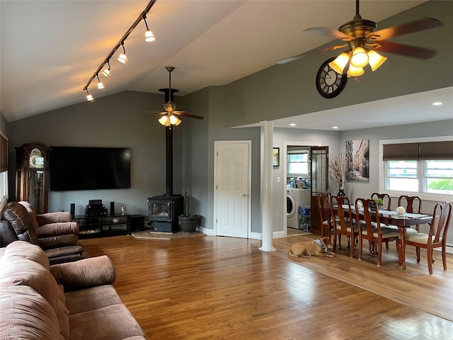2 Merritt Ln, Center Moriches, NY 11934 - living room with ceiling fan, vaulted ceiling, track lighting, wood finished floors, and a wood stove
