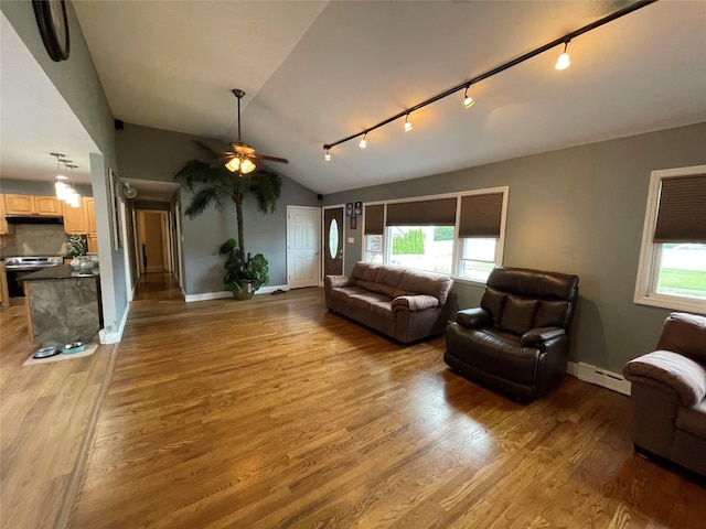 2 Merritt Ln, Center Moriches, NY 11934 - living room featuring track lighting, a baseboard heating unit, ceiling fan, light wood-type flooring, and vaulted ceiling