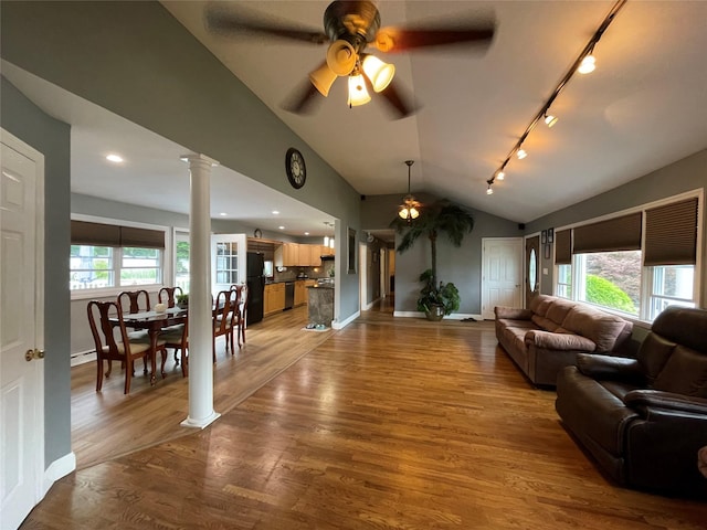 2 Merritt Ln, Center Moriches, NY 11934 - living room with a ceiling fan, track lighting, decorative columns, lofted ceiling, and light wood finished floors
