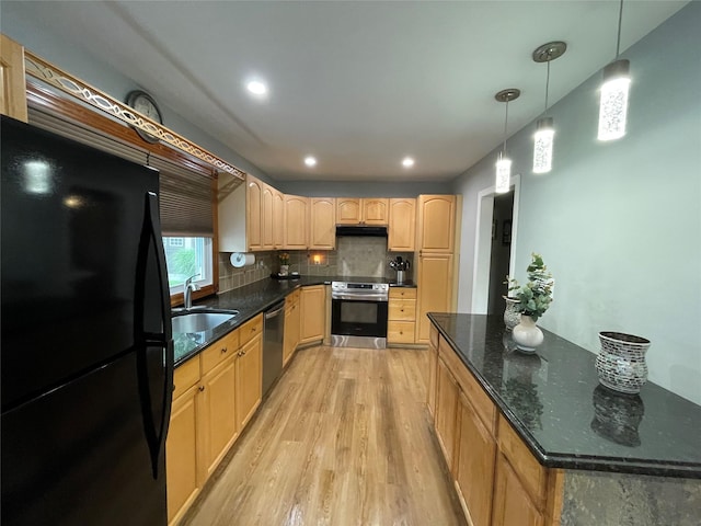 2 Merritt Ln, Center Moriches, NY 11934 - kitchen with appliances with stainless steel finishes, light wood finished floors, a sink, under cabinet range hood, and tasteful backsplash