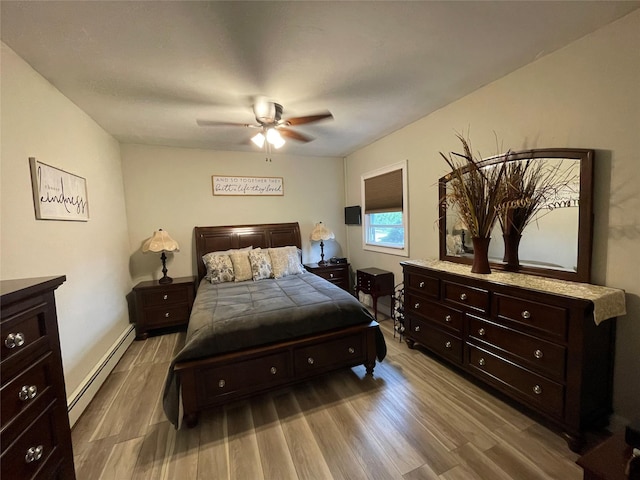 2 Merritt Ln, Center Moriches, NY 11934 - bedroom with a baseboard heating unit, wood finished floors, a ceiling fan, and baseboards