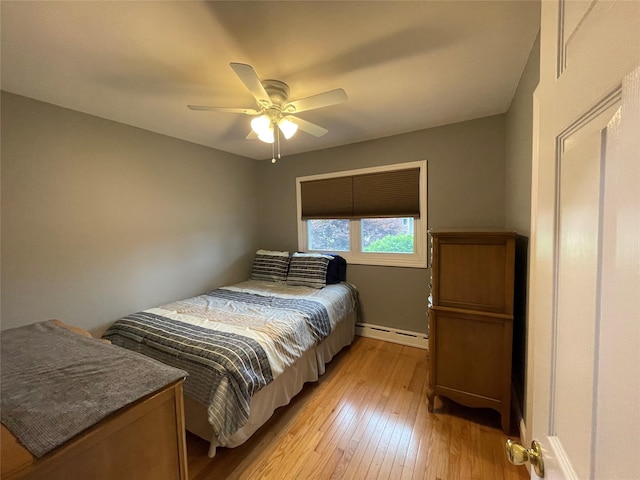 2 Merritt Ln, Center Moriches, NY 11934 - bedroom with a baseboard heating unit, light wood-style floors, baseboards, and ceiling fan