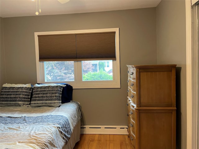 2 Merritt Ln, Center Moriches, NY 11934 - bedroom with baseboard heating and wood finished floors