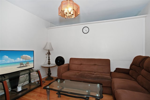 83-37 Saint James Ave Unit 2R, Elmhurst, NY 11373 - living area featuring a chandelier, wood finished floors, and baseboards