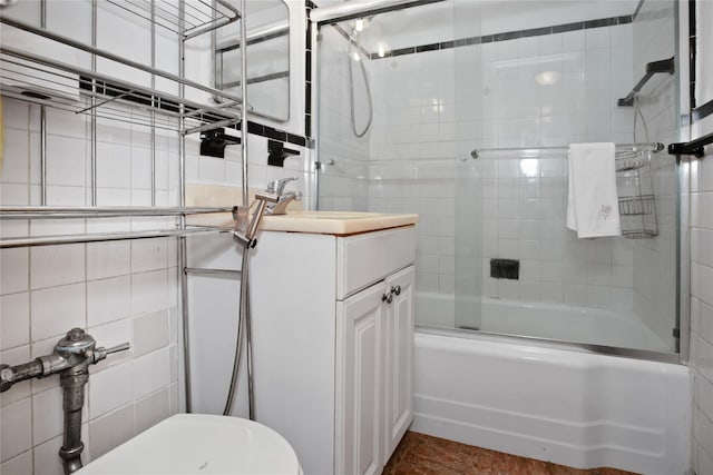 83-37 Saint James Ave Unit 2R, Elmhurst, NY 11373 - full bathroom with combined bath / shower with glass door, vanity, and tile walls