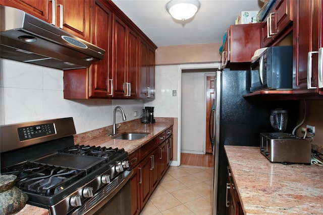 83-37 Saint James Ave Unit 2R, Elmhurst, NY 11373 - kitchen featuring stainless steel gas stove, range hood, dark brown cabinets, and light stone countertops