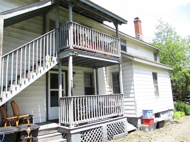 2 Van Wardt Pl, Tappan, NY 10983 - rear view of property featuring stairway, covered porch, and a chimney