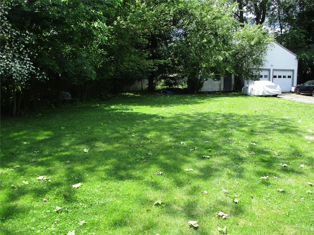 2 Van Wardt Pl, Tappan, NY 10983 - view of grassy yard with an attached garage, an outdoor structure, and driveway